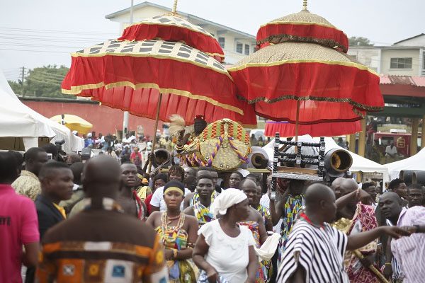 Royal umbrellas rise above the procession in Oguaa