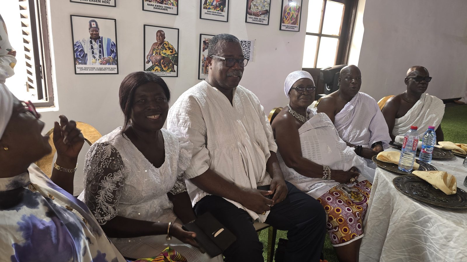 Guests at the reception for Nananom at the palace, beneath portraits of the chiefs